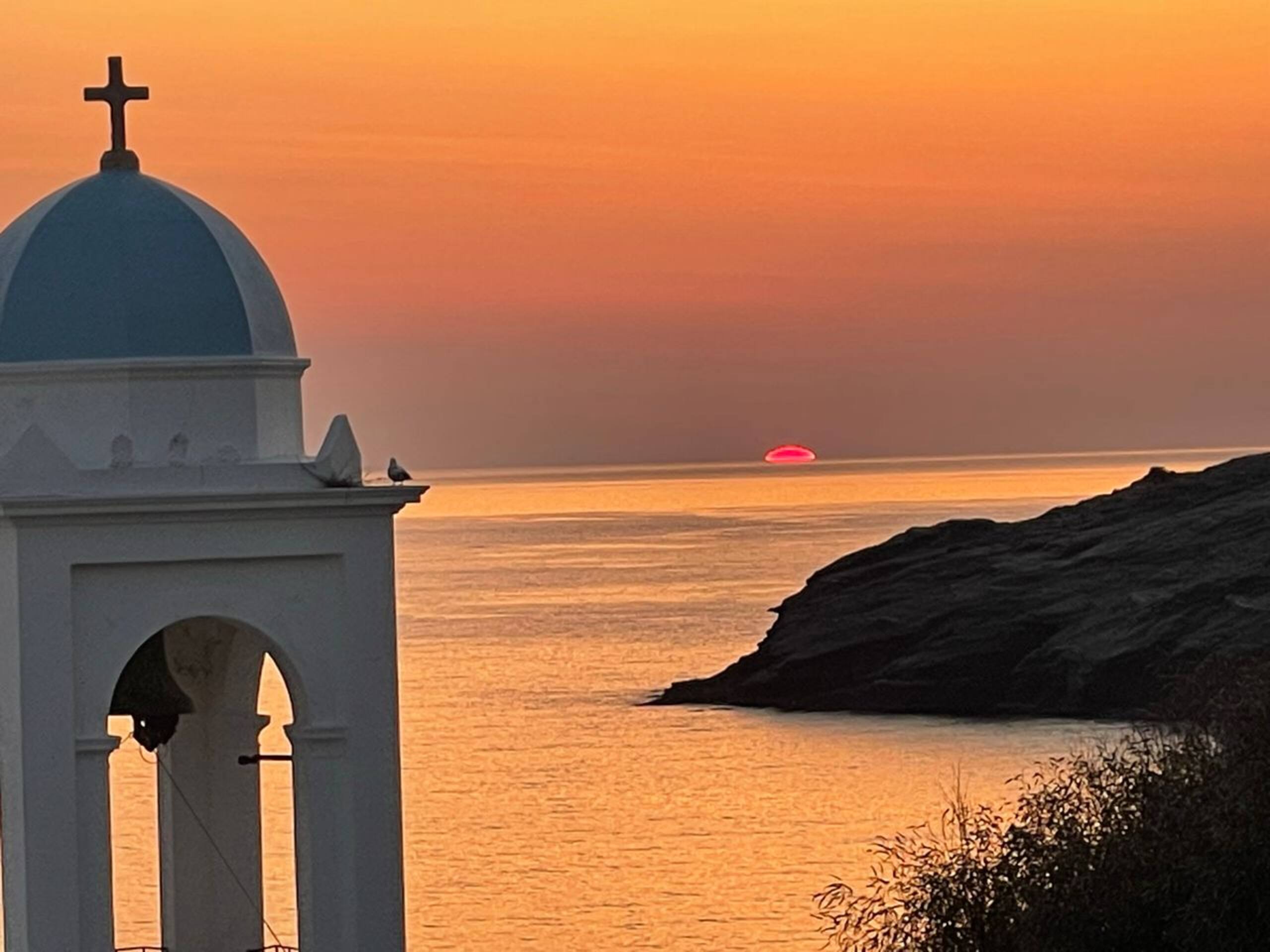 Bell tower at sunset over the bay