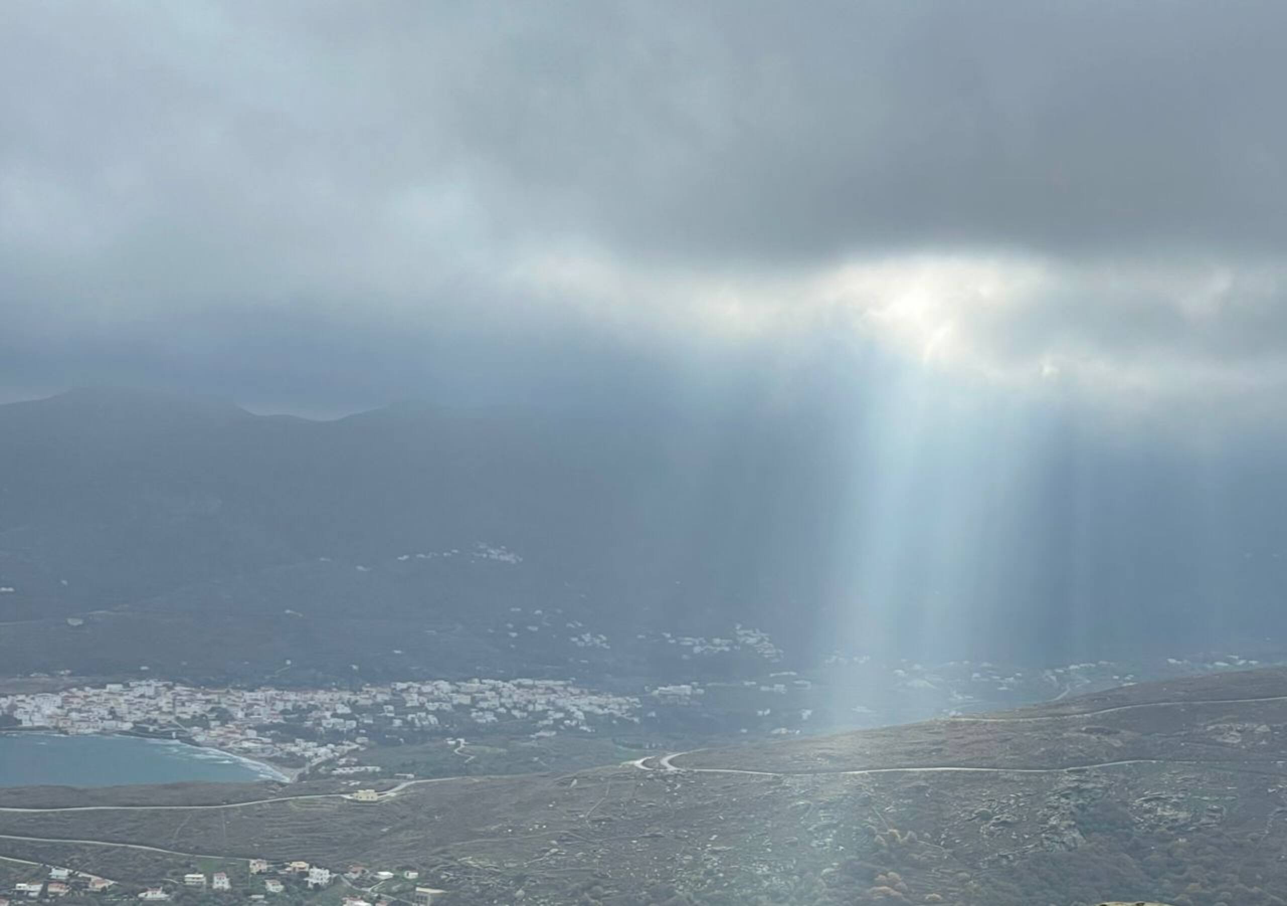Mountain and sea panorama with dramatic light rays